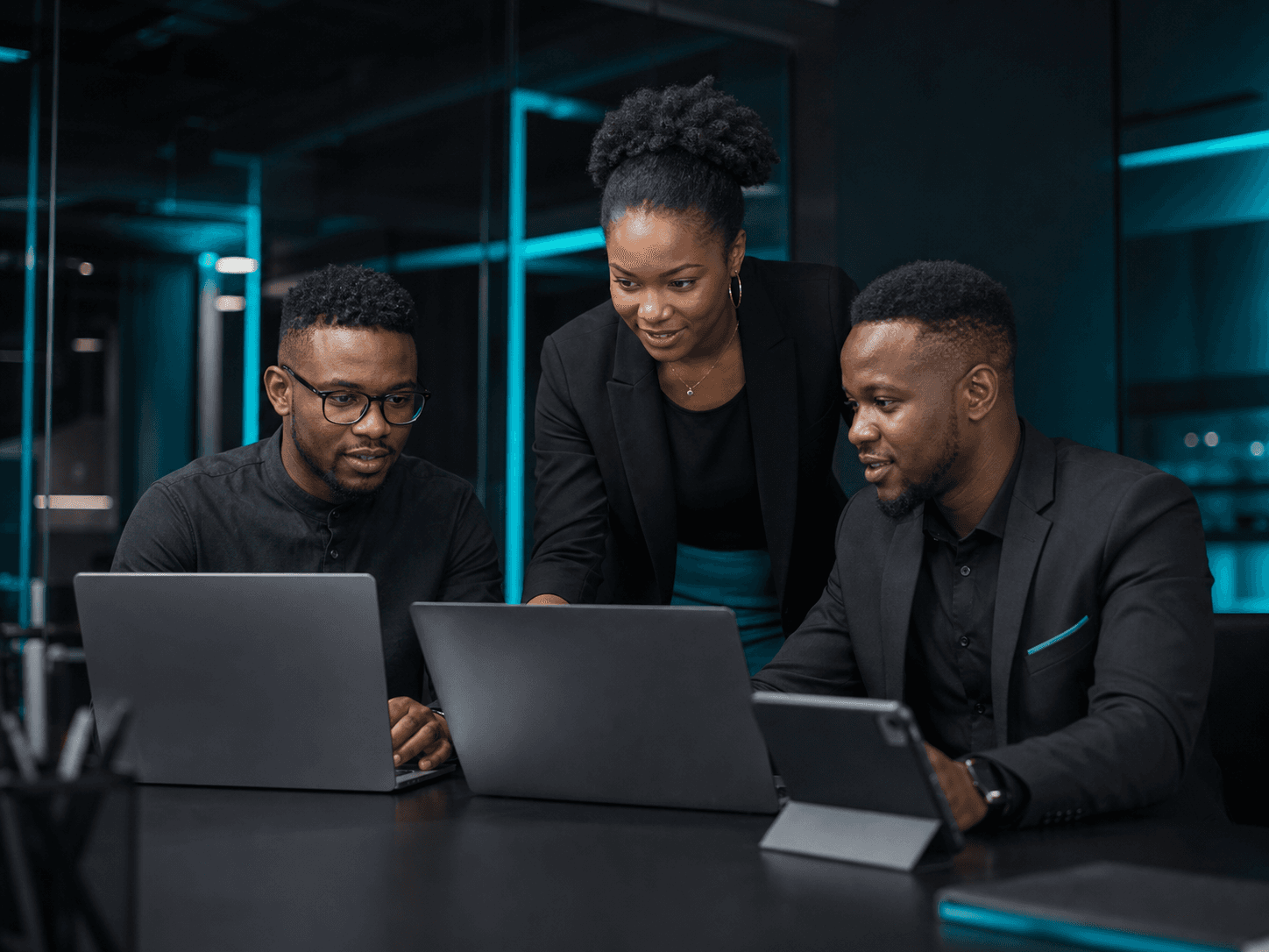Team reviewing a system together on laptops